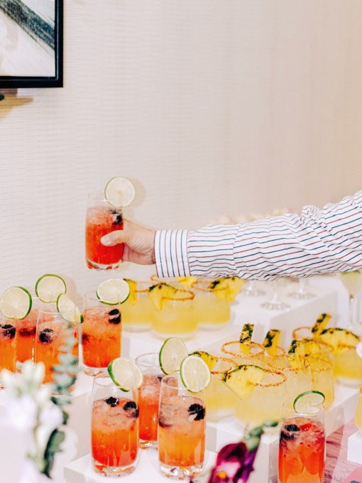 Two guests toasting with Club Citrine mocktails at an event