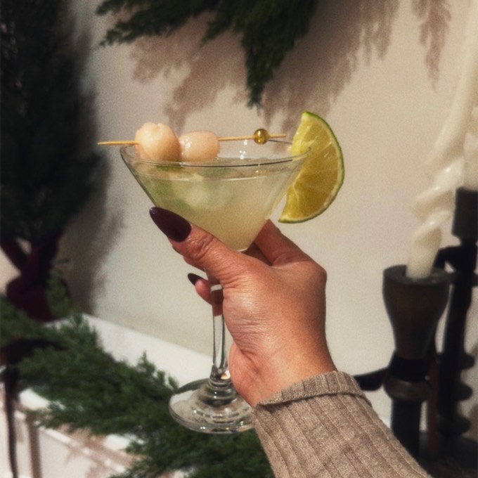 A guest holding a handcrafted citrus mocktail